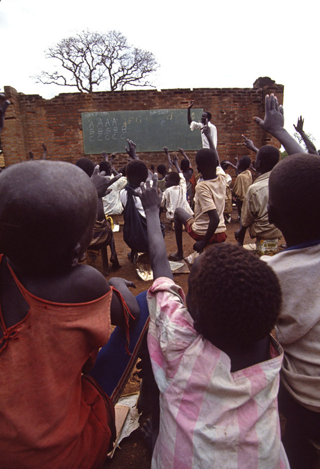 Their schools destroyed, children and teachers make do with a standing wall and black board : CRISIS : Viviane Moos |  Documentary Photographer